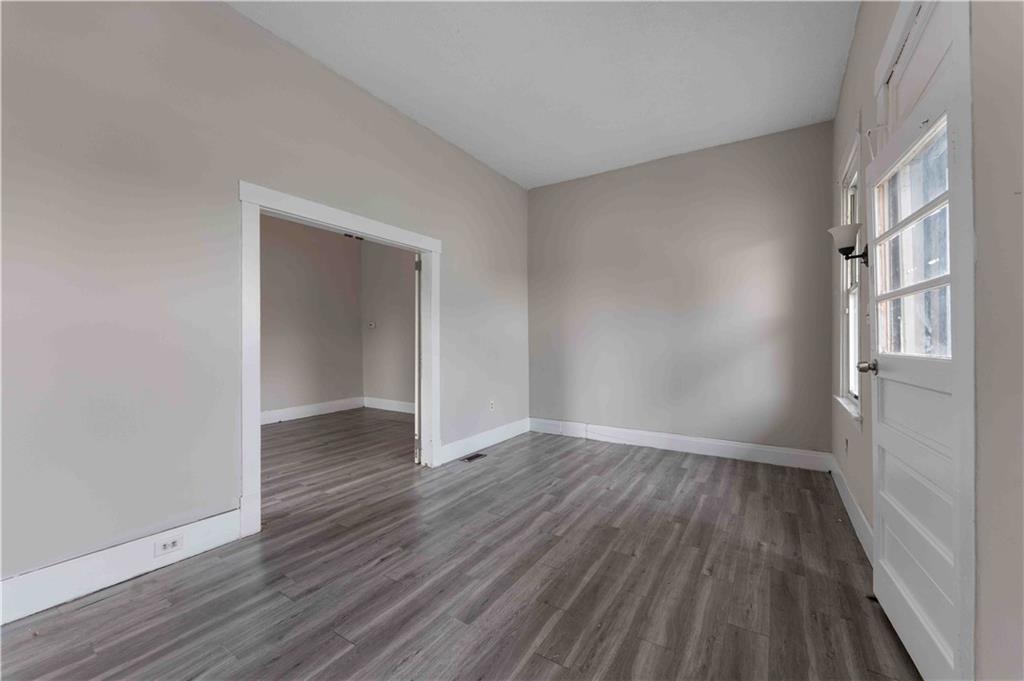 254-256 Pennsylvania Avenue Rochester, PA 15074 - Photo 20 of 32 a view of an empty room with wooden floor and a window