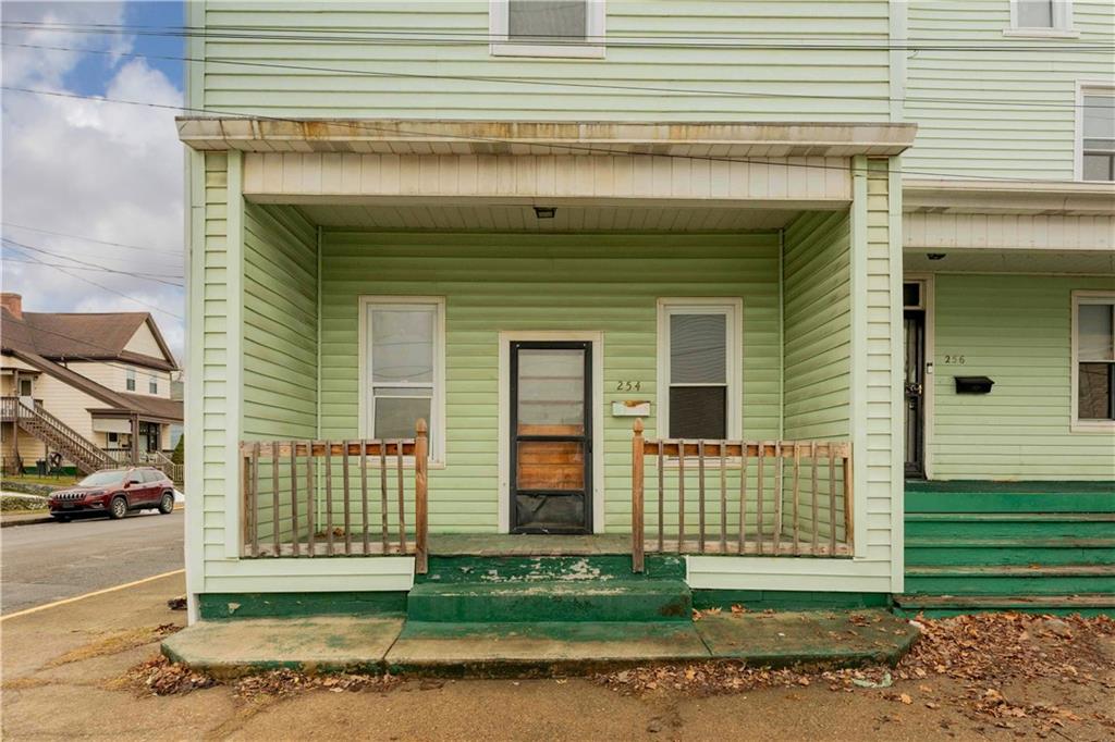 254-256 Pennsylvania Avenue Rochester, PA 15074 - Photo 2 of 32 a front view of a house with a garden