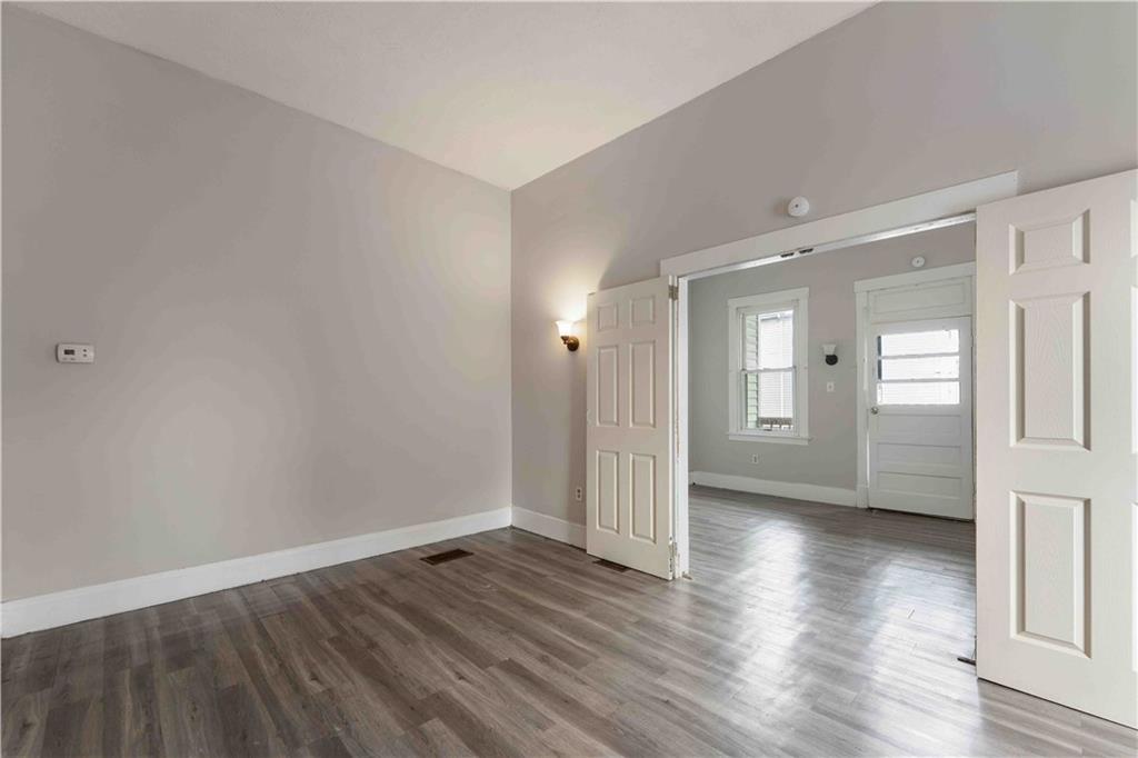 254-256 Pennsylvania Avenue Rochester, PA 15074 - Photo 22 of 32 wooden floor in an empty room with a window