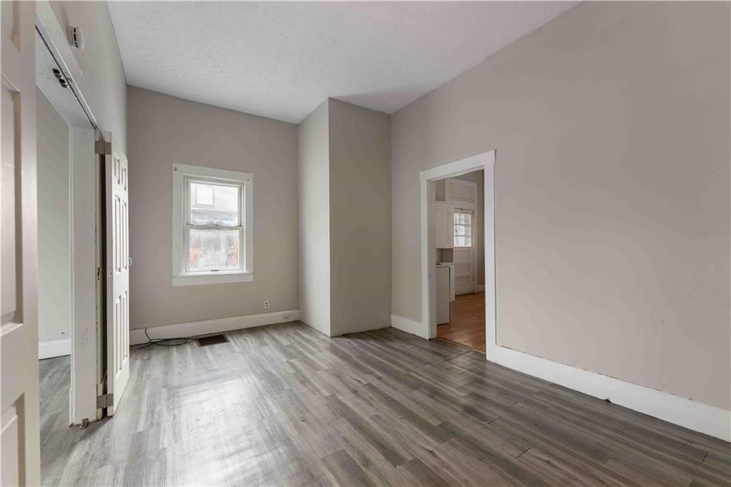 254-256 Pennsylvania Avenue Rochester, PA 15074 - Photo 24 of 32 an empty room with wooden floor and windows
