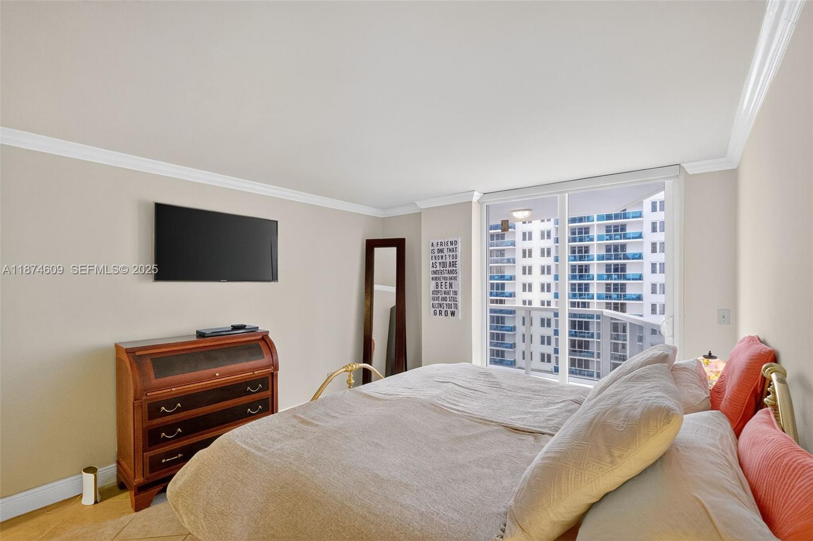2401 Collins Avenue, Unit 1005 Miami Beach, FL 33140 - Photo 12 of 19 a bedroom with a bed and a flat screen tv
