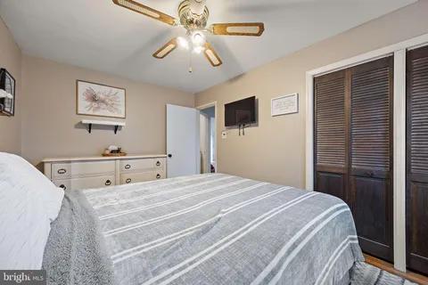 a bedroom with a large bed and a flat screen tv