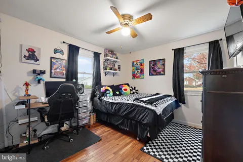 a bedroom with furniture and wooden floor