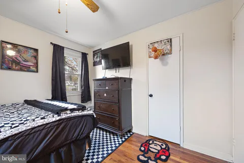 a bedroom with a bed and flat screen tv
