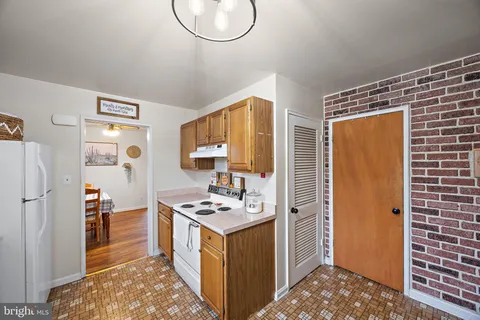 a kitchen with stainless steel appliances a refrigerator and a stove top oven
