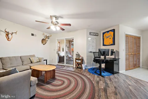 a living room with furniture a rug and a chandelier
