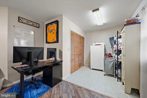 a view of a workspace with furniture and a window