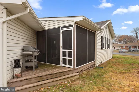 a view of a patio with table and chairs and wooden floor