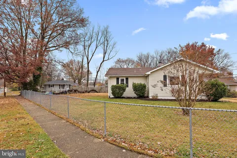 a view of a house with a yard covered with snow in the outdoor space