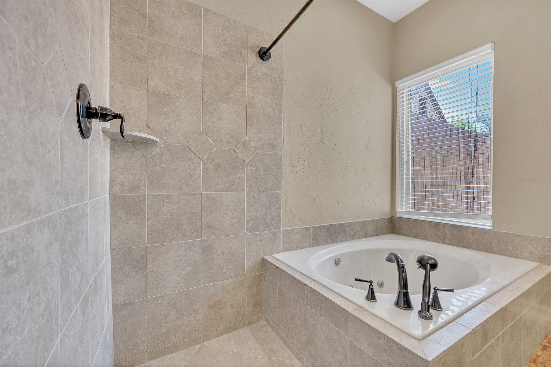7659 Ameswood Road Houston, TX 77095 - Photo 14 of 24 a bathroom with a tub and a shower