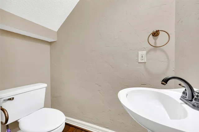 a bathroom with a sink mirror and toilet