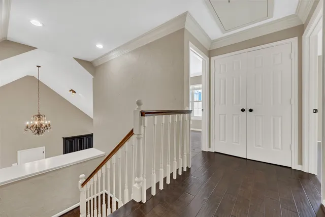 a view of a hallway with entryway wooden floor and front door