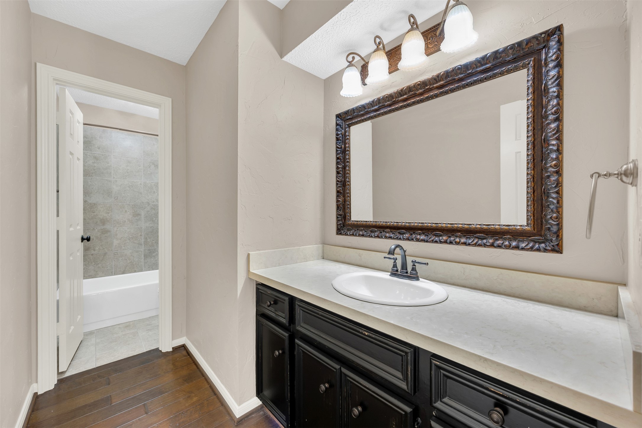 7659 Ameswood Road Houston, TX 77095 - Photo 18 of 24 a bathroom with a sink and a mirror