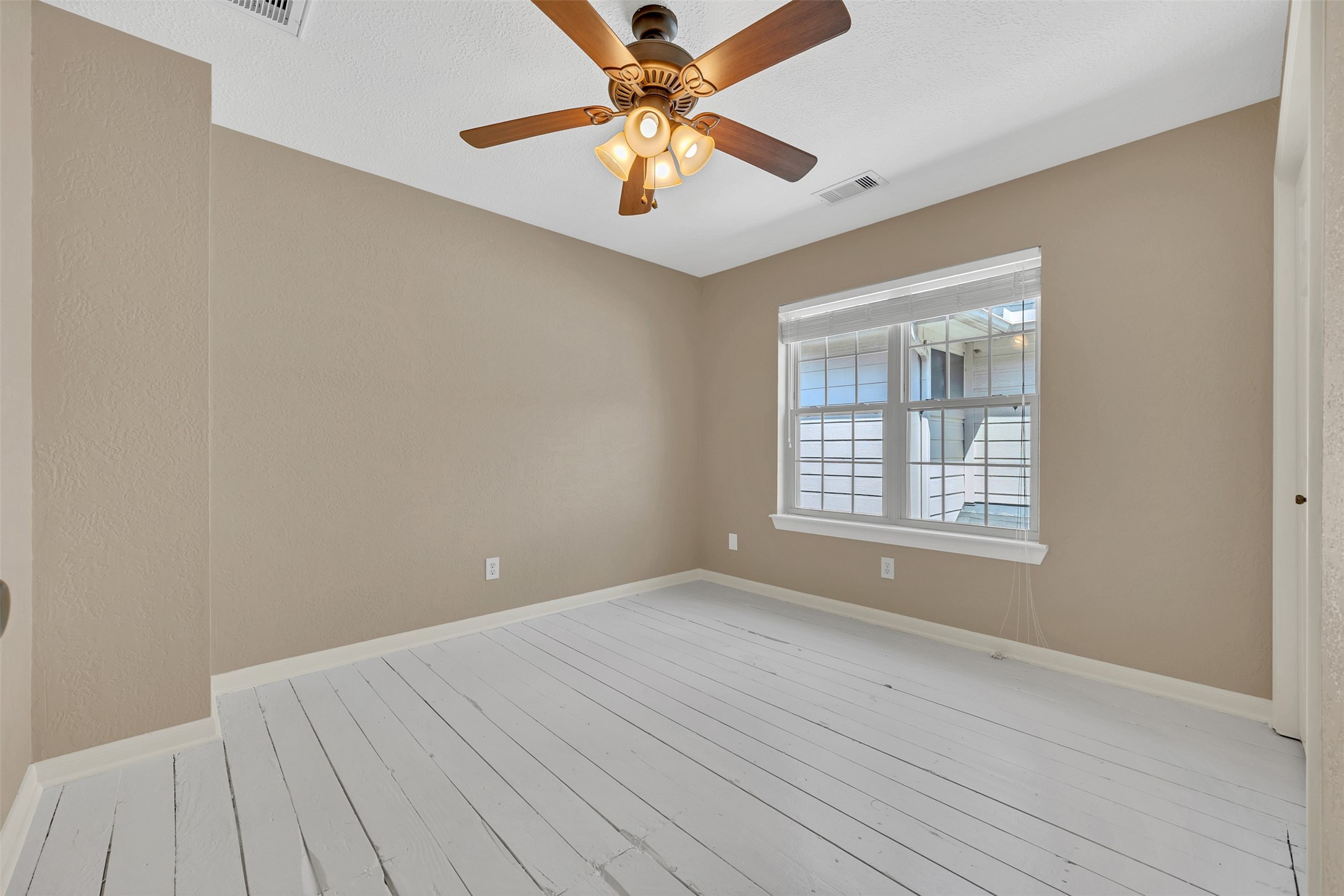 7659 Ameswood Road Houston, TX 77095 - Photo 19 of 24 a view of a room with window and ceiling fan
