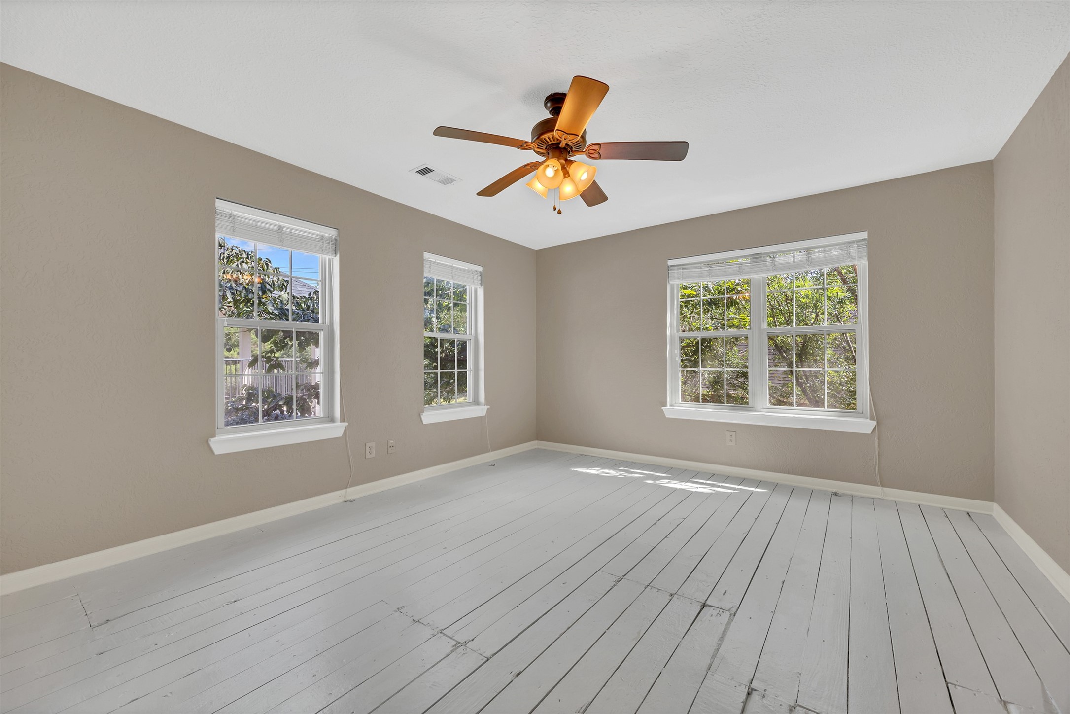 7659 Ameswood Road Houston, TX 77095 - Photo 20 of 24 a view of an empty room with window and wooden floor