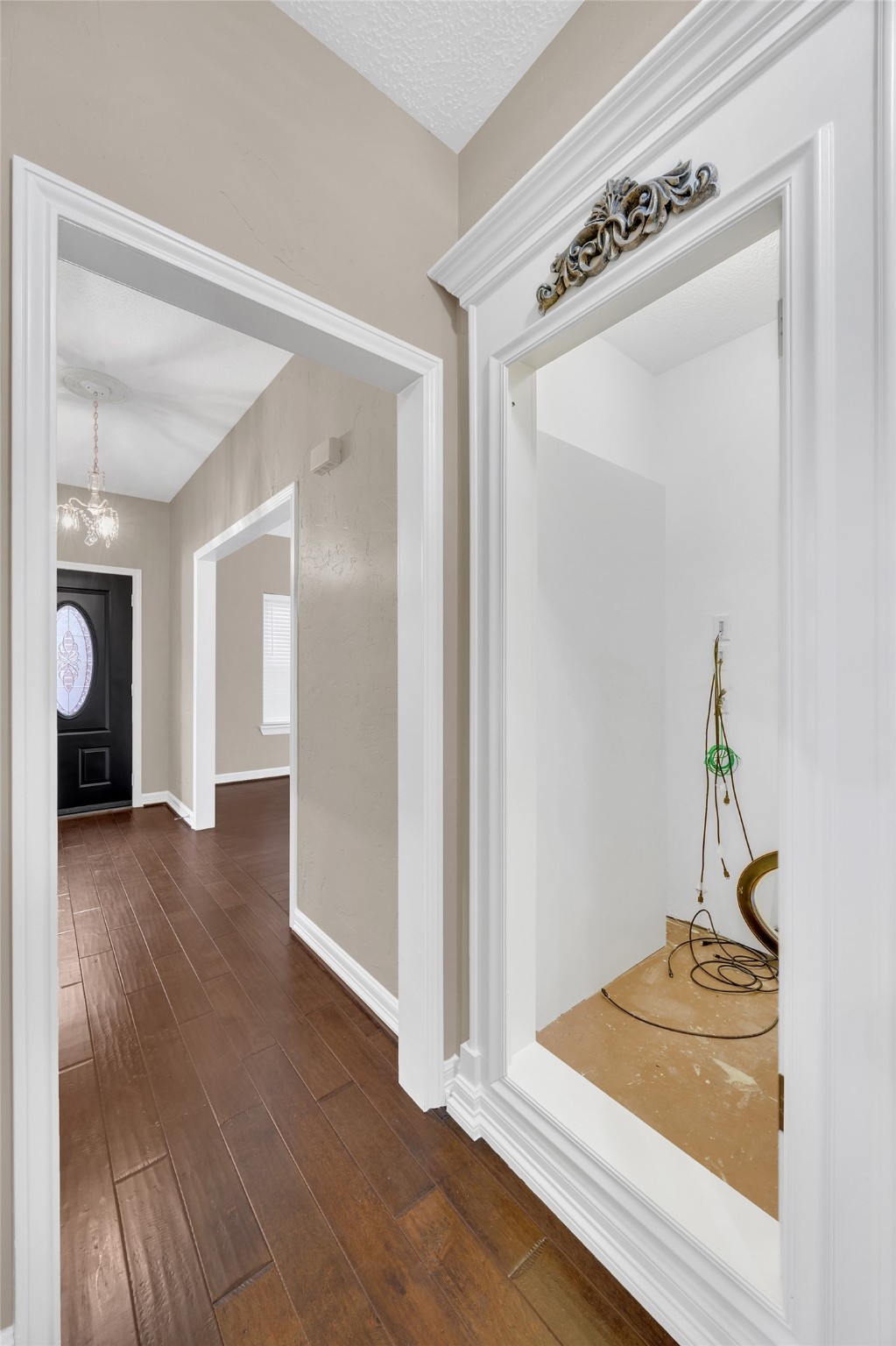 7659 Ameswood Road Houston, TX 77095 - Photo 2 of 24 a view of a hallway to a room and wooden floor