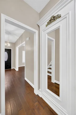 a view of a hallway with wooden floor