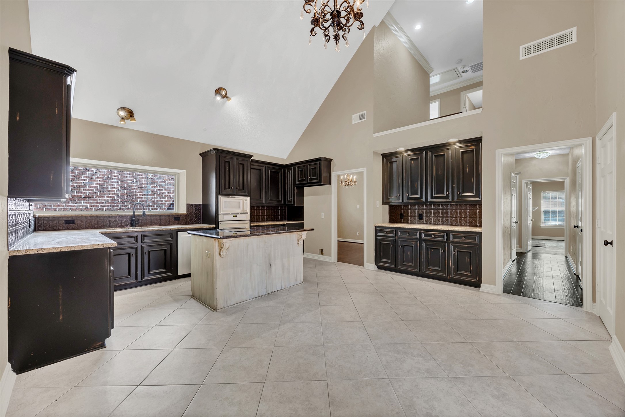 7659 Ameswood Road Houston, TX 77095 - Photo 4 of 24 a large kitchen with stainless steel appliances a stove a sink and a refrigerator