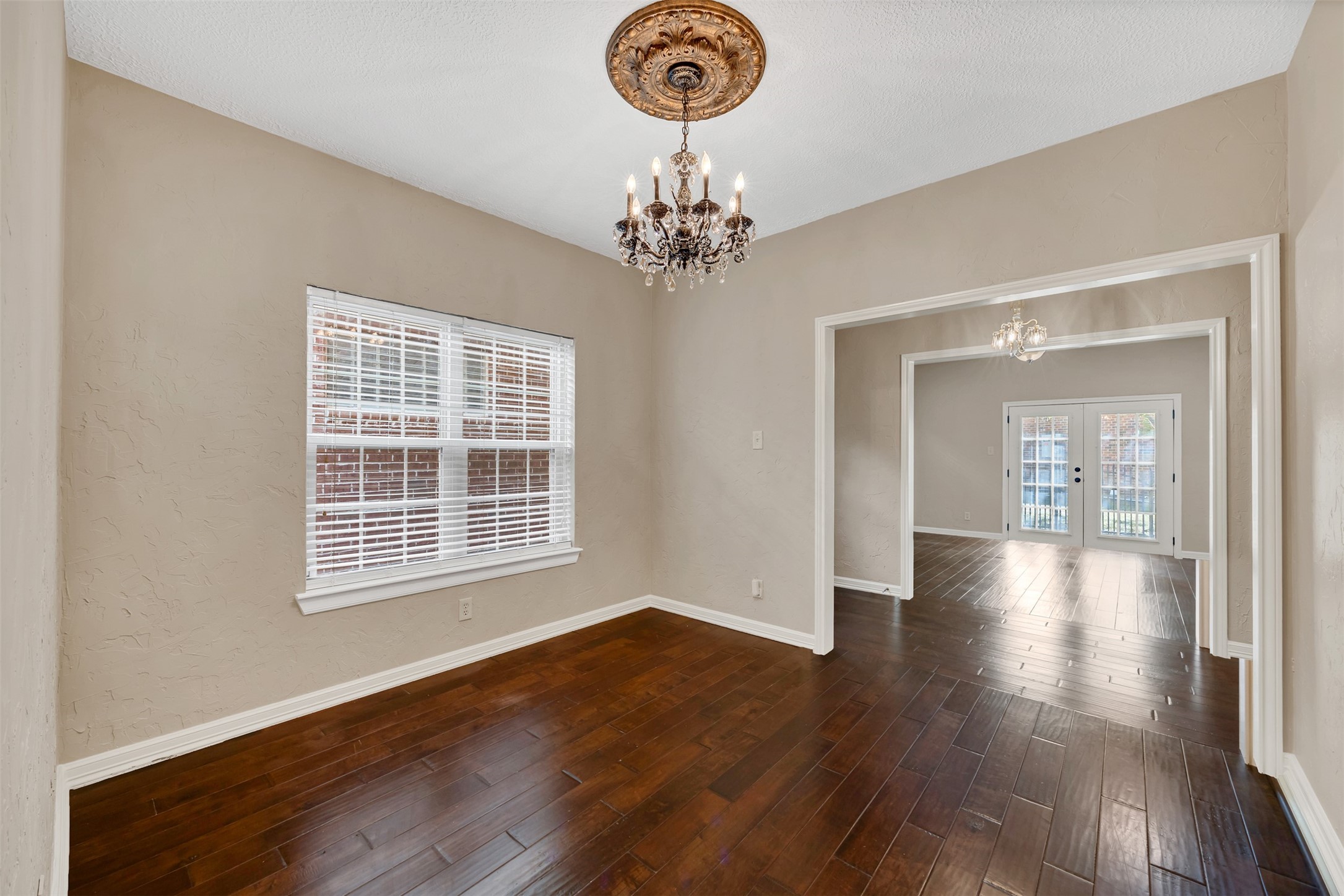 7659 Ameswood Road Houston, TX 77095 - Photo 8 of 24 a view of an empty room with wooden floor and a window