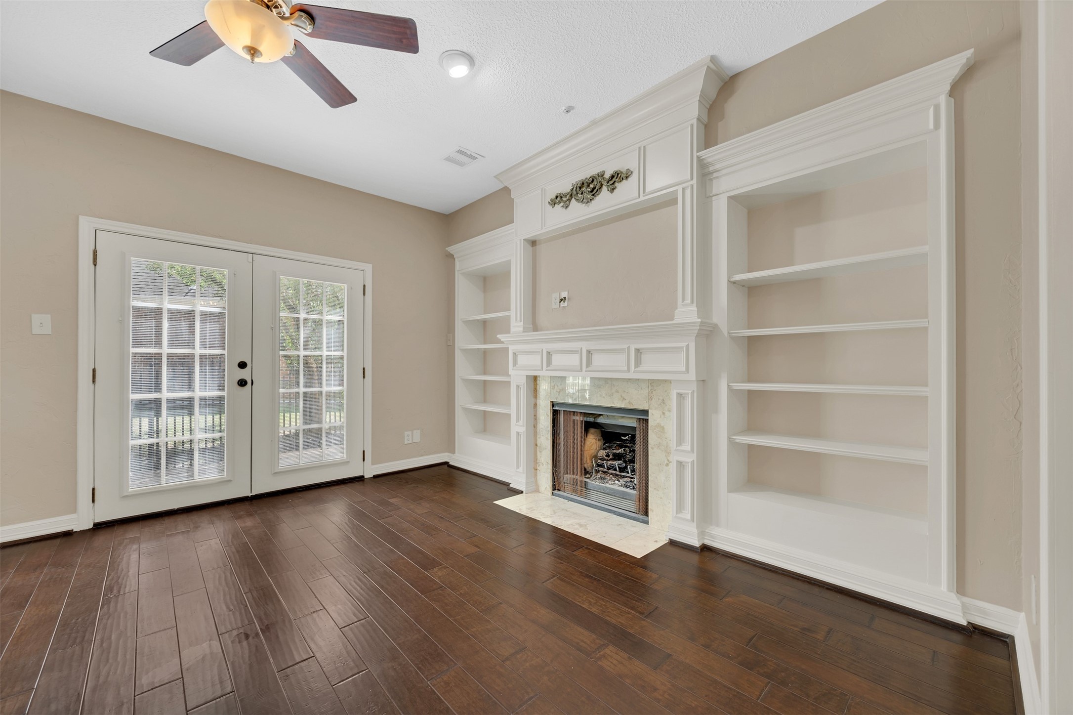 7659 Ameswood Road Houston, TX 77095 - Photo 9 of 24 a view of an empty room with wooden floor and a window