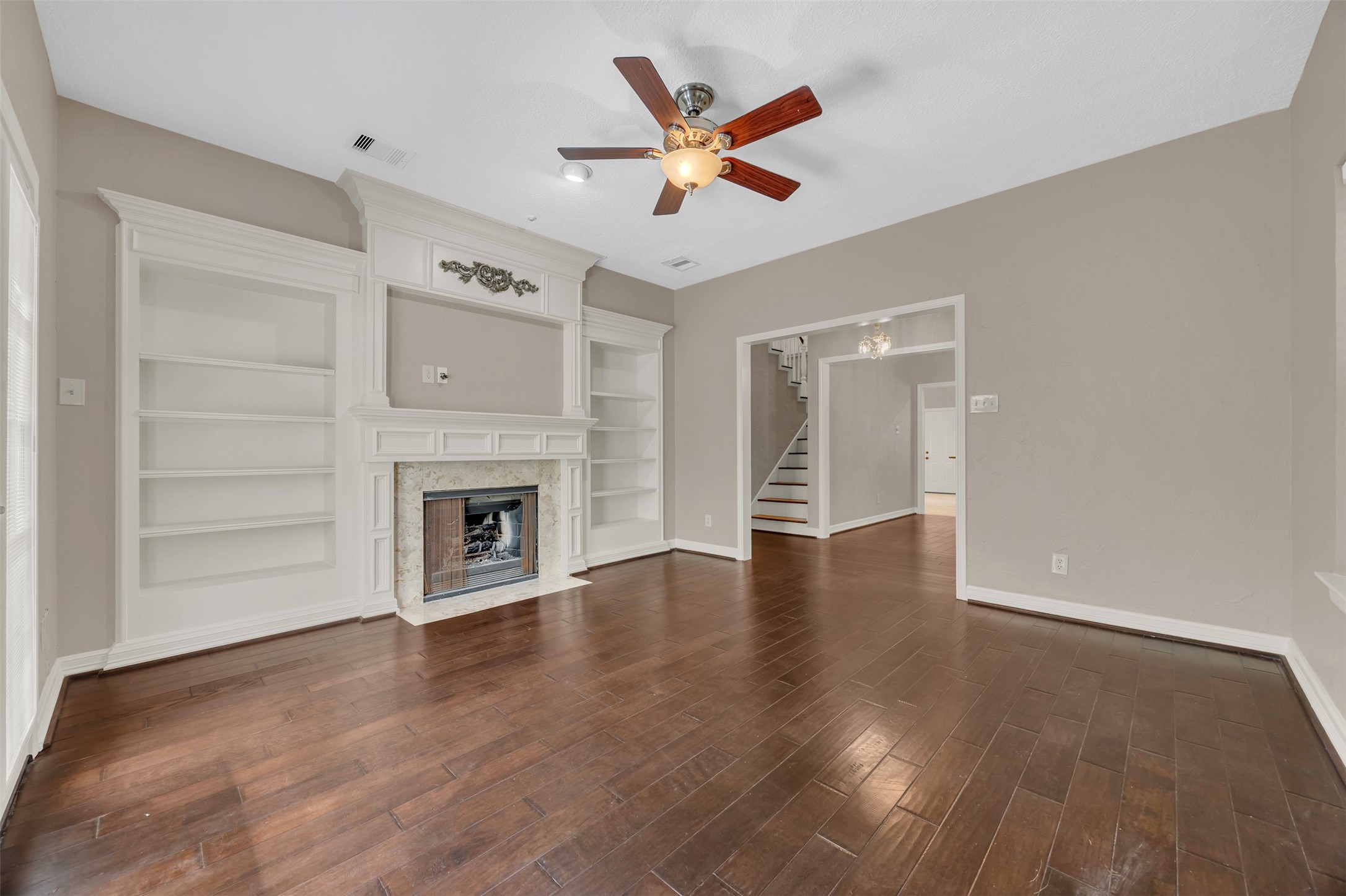 7659 Ameswood Road Houston, TX 77095 - Photo 10 of 24 a view of an empty room with a fireplace and a window