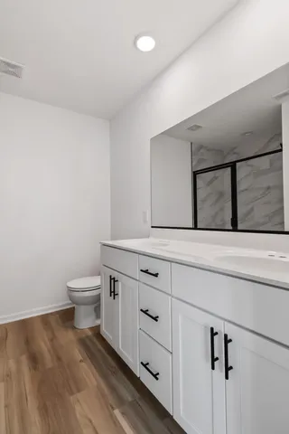 a bathroom with a glass shower door