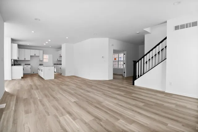 a view of a kitchen with furniture and wooden floor