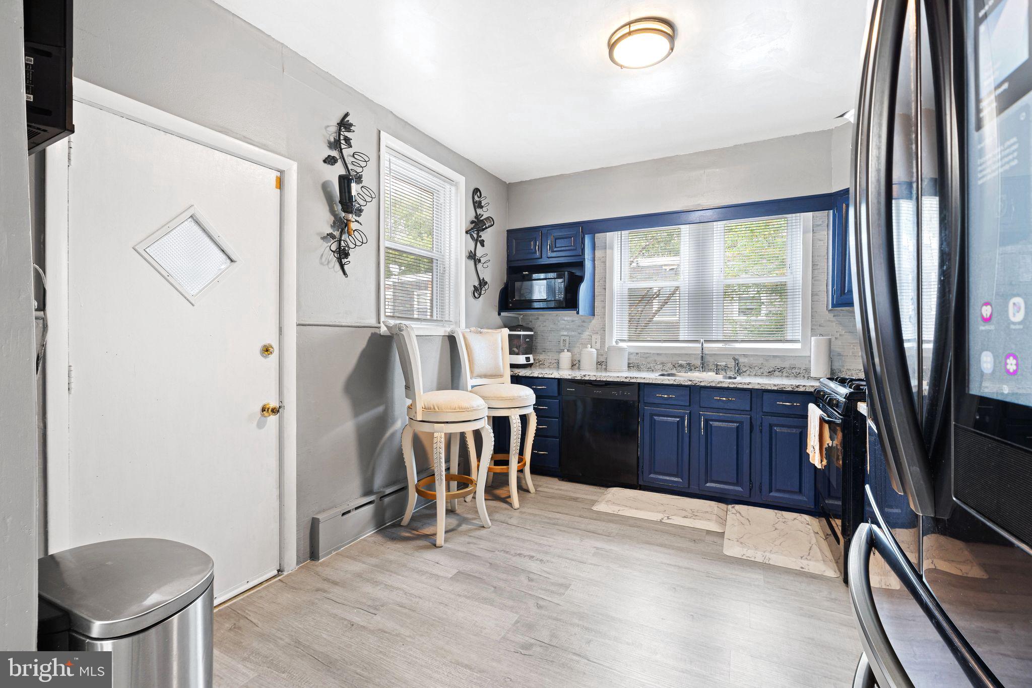 5431 Akron Street Philadelphia, PA 19124 - Photo 11 of 32 a kitchen with a table chairs refrigerator and microwave