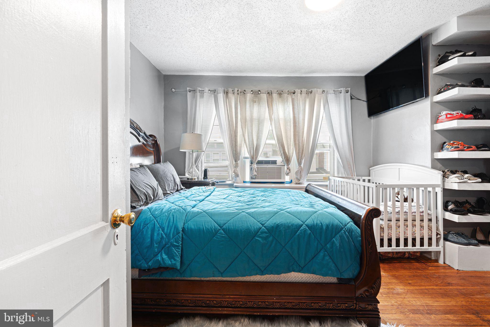 5431 Akron Street Philadelphia, PA 19124 - Photo 15 of 32 a bedroom with a bed and a window