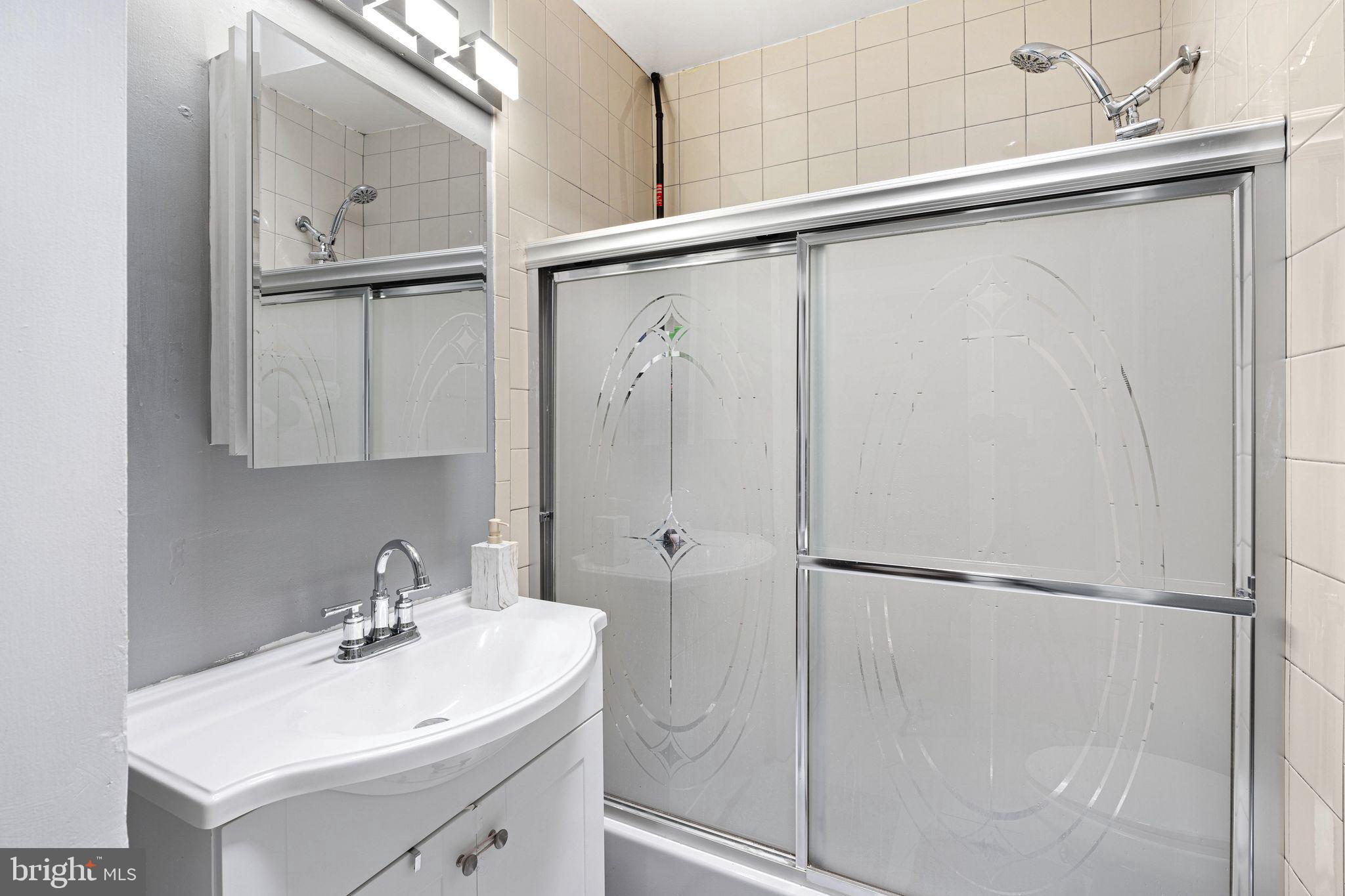 5431 Akron Street Philadelphia, PA 19124 - Photo 19 of 32 a bathroom with a sink and mirror