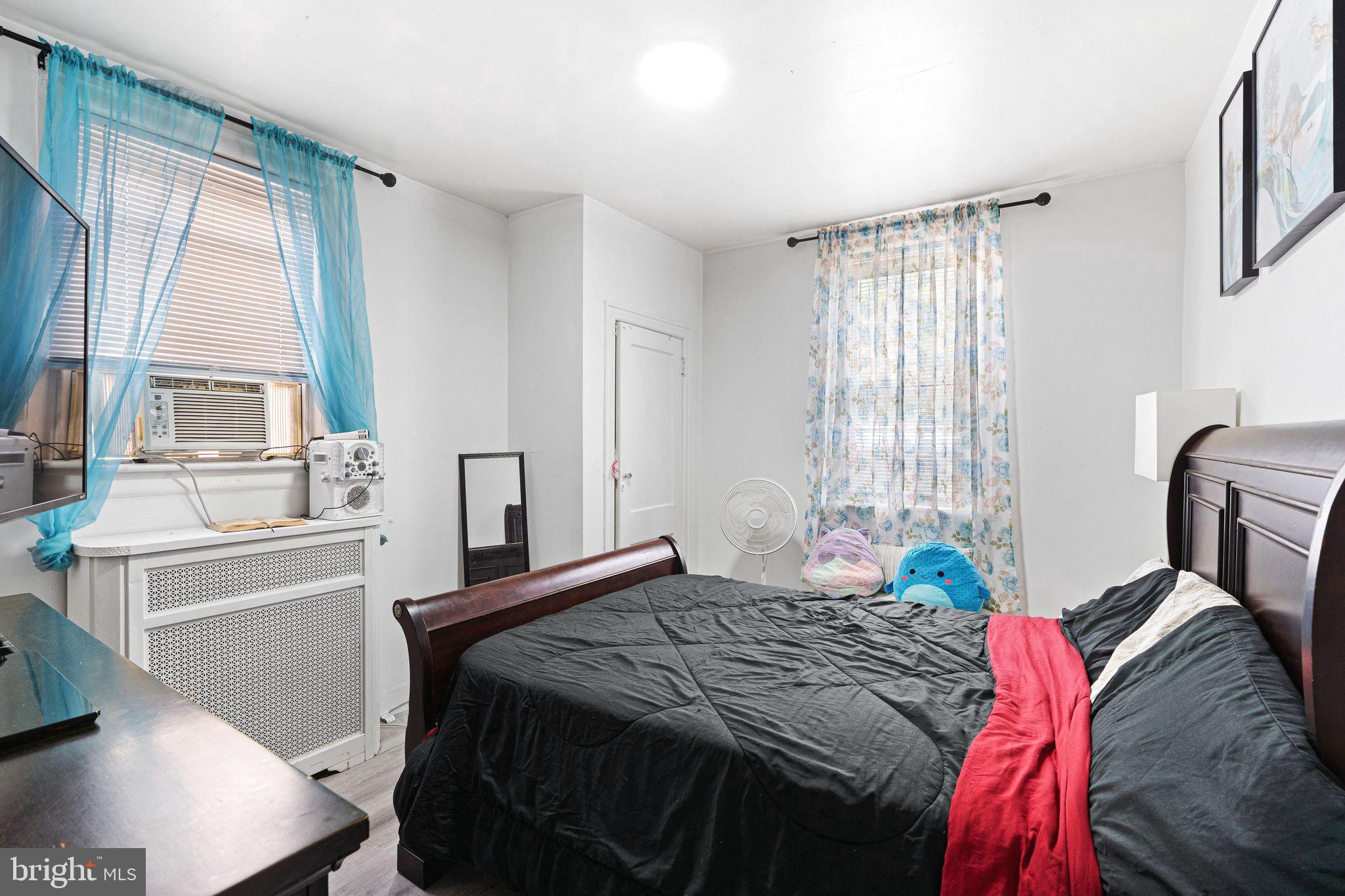 5431 Akron Street Philadelphia, PA 19124 - Photo 20 of 32 a bedroom with a bed and a large window