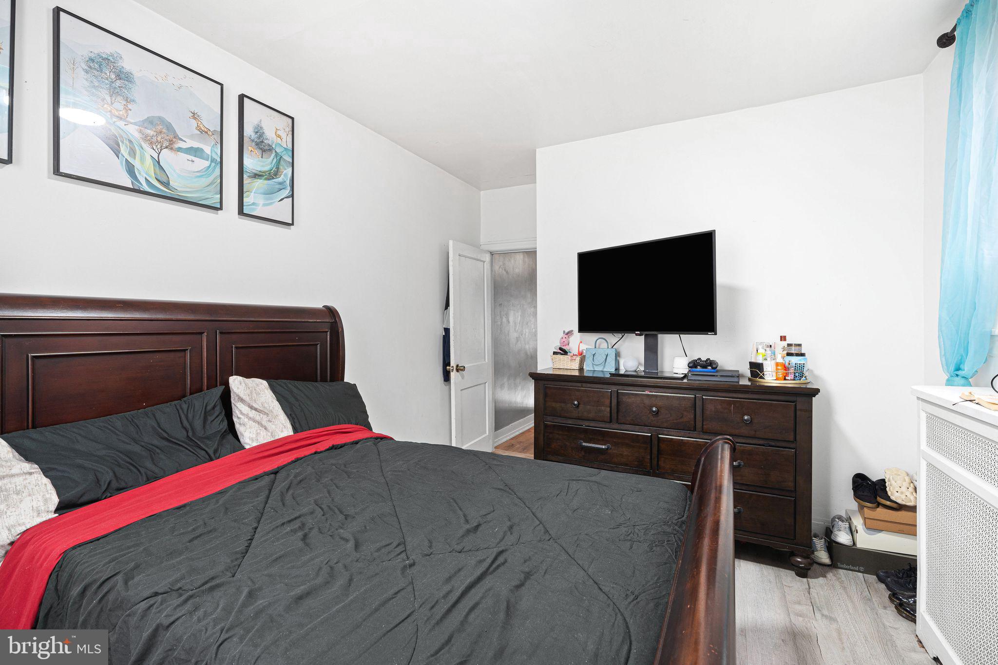 5431 Akron Street Philadelphia, PA 19124 - Photo 21 of 32 a bedroom with a bed and a flat screen tv