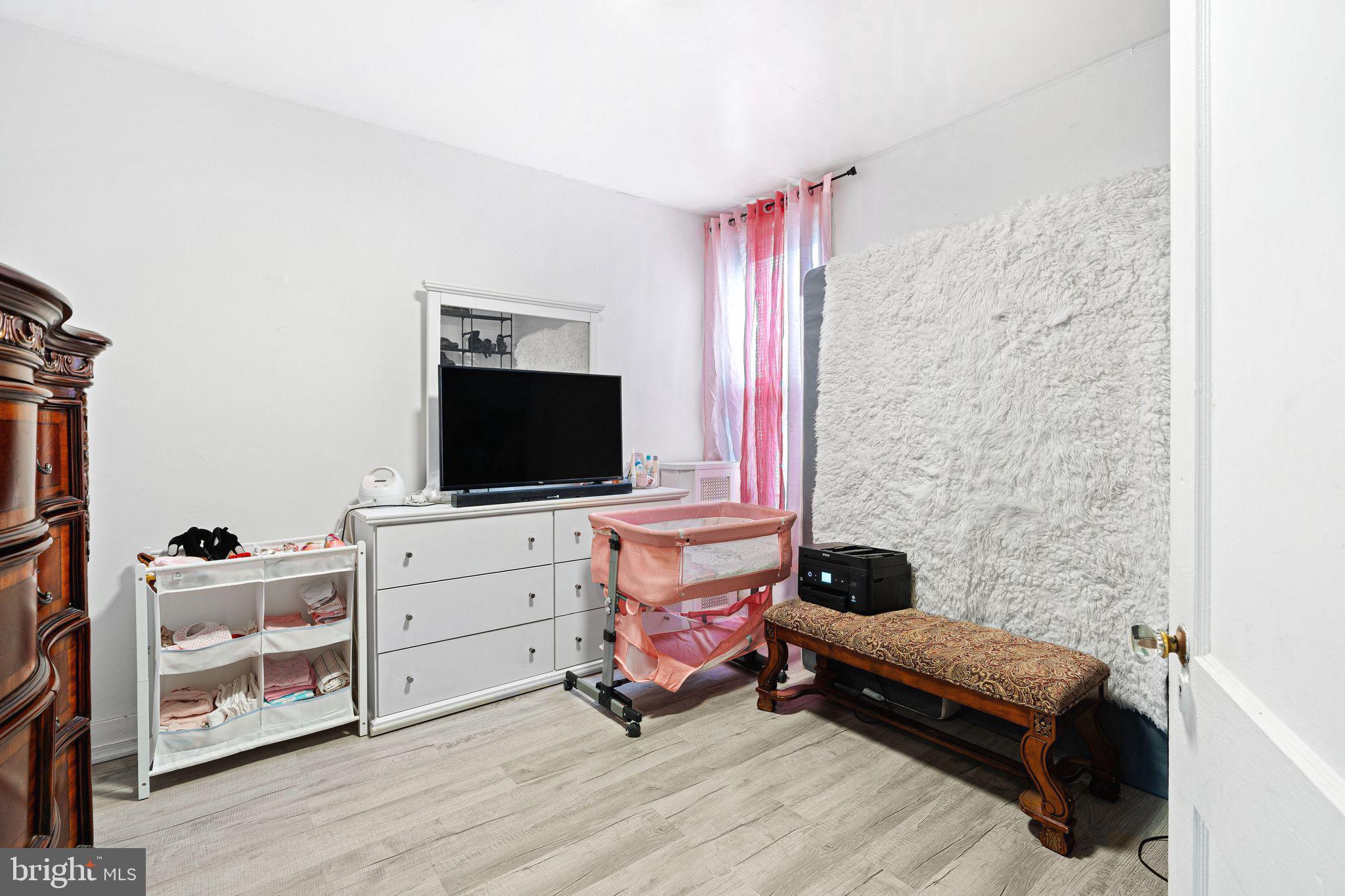 5431 Akron Street Philadelphia, PA 19124 - Photo 22 of 32 a bedroom with furniture and a flat screen tv