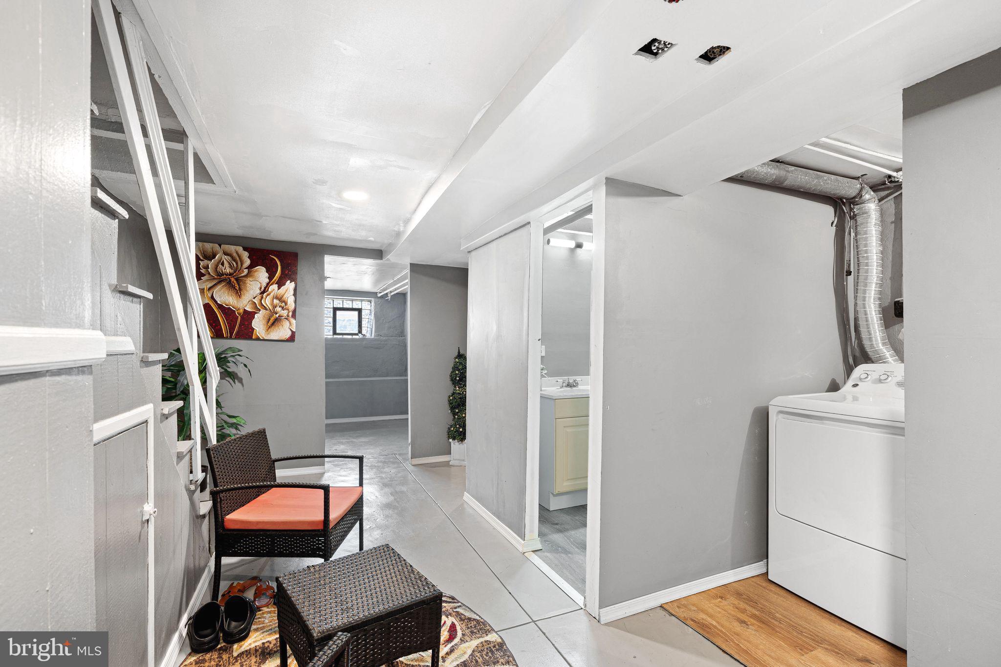5431 Akron Street Philadelphia, PA 19124 - Photo 27 of 32 a view of a hallway with a livingroom and furniture
