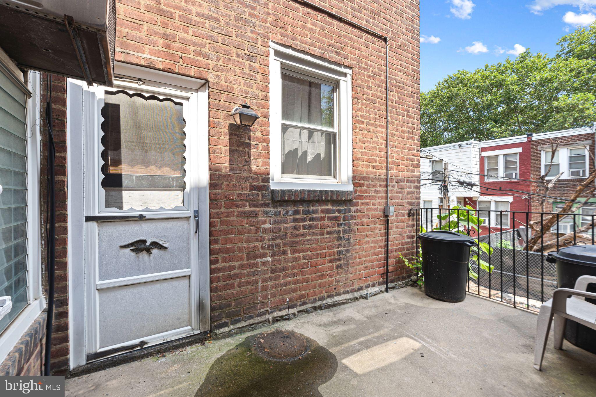 5431 Akron Street Philadelphia, PA 19124 - Photo 29 of 32 a view of a door and chair and table in the patio