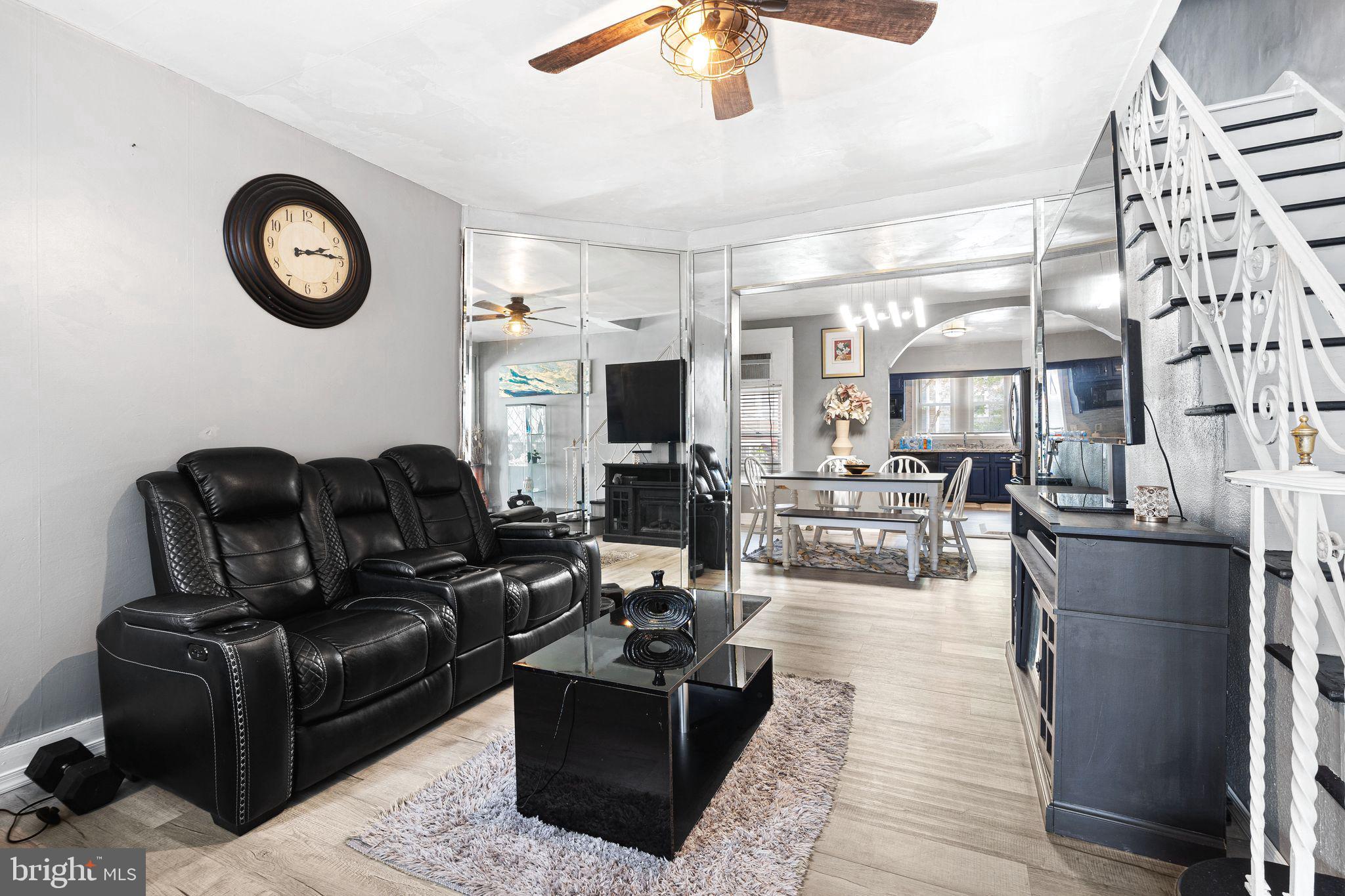 5431 Akron Street Philadelphia, PA 19124 - Photo 6 of 32 a living room with furniture a clock on wall and a chandelier