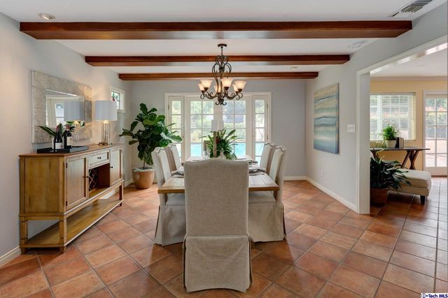 a living room with furniture a chandelier and a fireplace