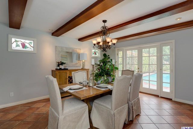 a view of a dining room with furniture and a chandelier