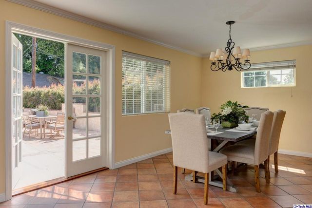 a dining room with furniture a chandelier and wooden floor