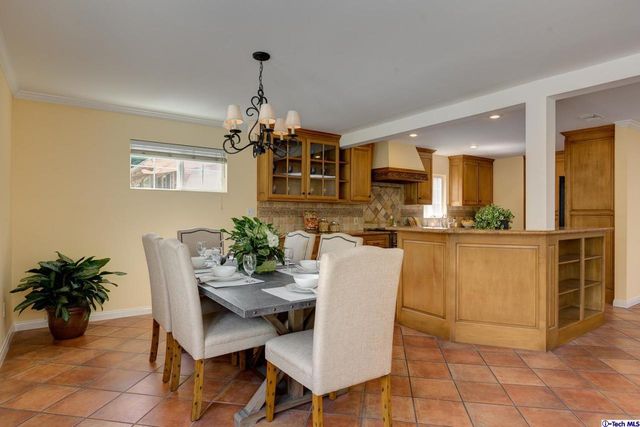 a view of a dining room with furniture and a chandelier