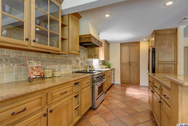 a kitchen with stainless steel appliances granite countertop a sink and cabinets