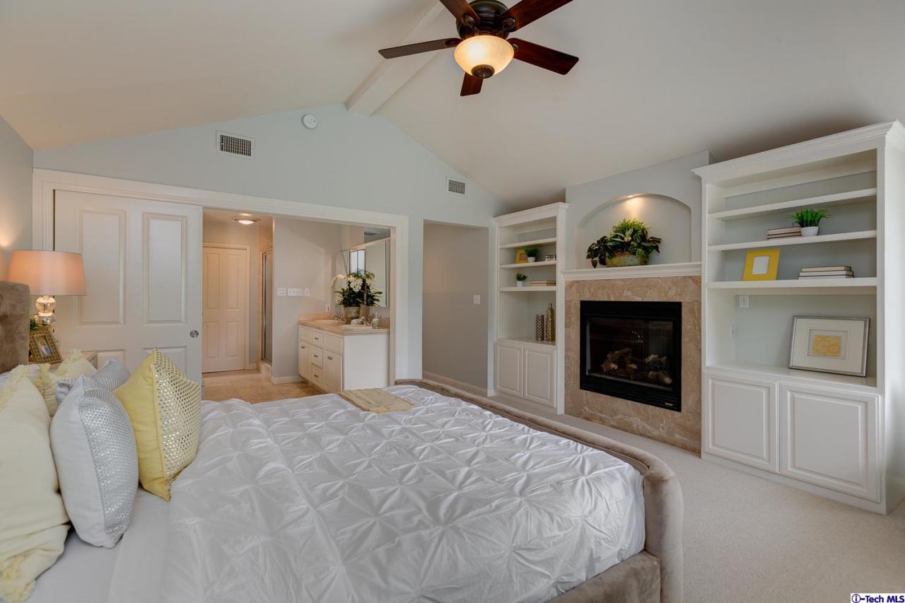 804 Milan Avenue South Pasadena, CA 91030 - Photo 31 of 58 a spacious bedroom with a bed and a fireplace