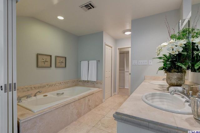 a bedroom with a bed table chair and a window