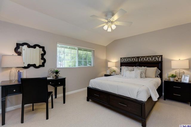 a front view of a house with swimming pool garden and patio