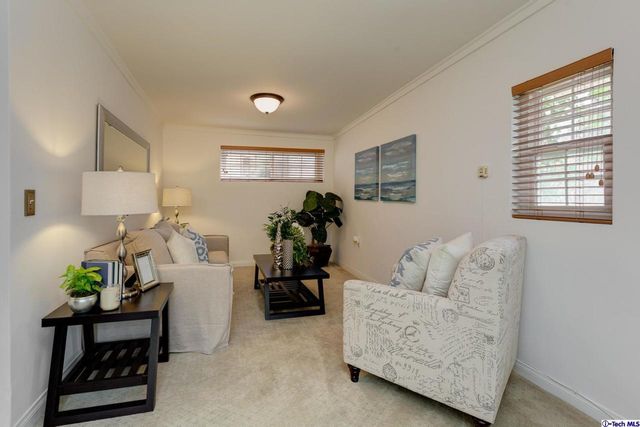 a bedroom with a large bed and a potted plant