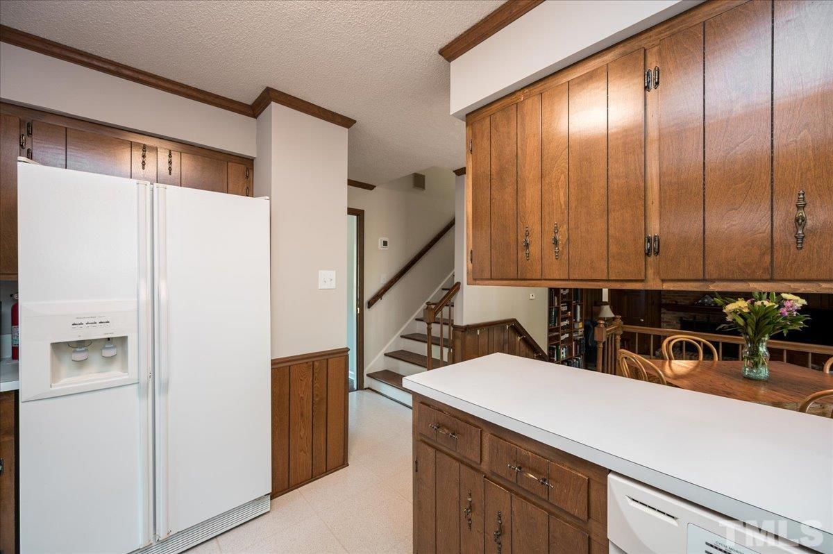 2012 Eagleton Circle Raleigh, NC 27609 - Photo 14 of 29 a kitchen with a sink a refrigerator and cabinets