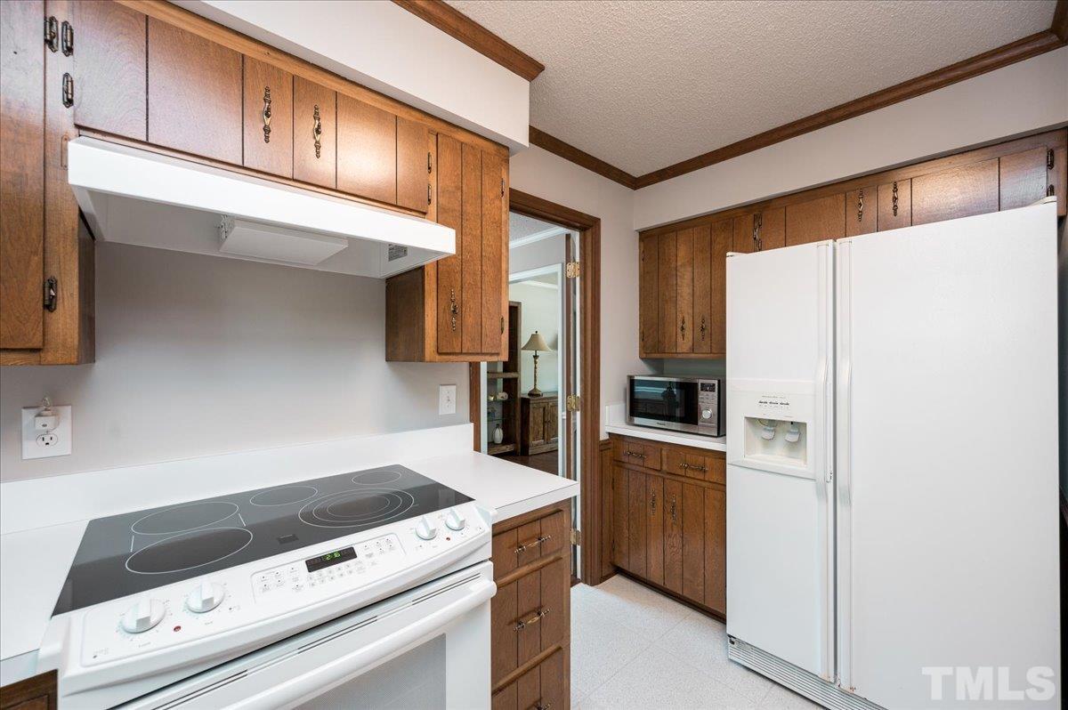 2012 Eagleton Circle Raleigh, NC 27609 - Photo 15 of 29 a kitchen with a refrigerator and a stove
