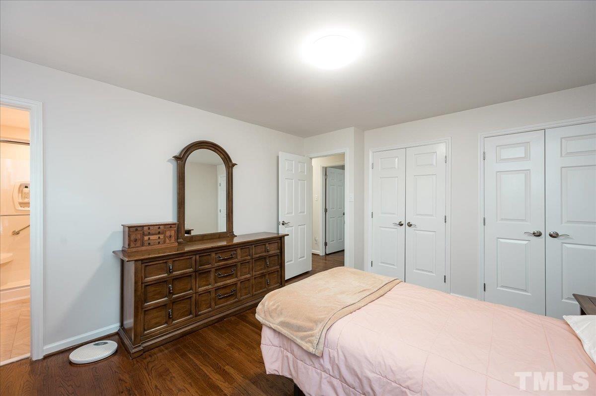 2012 Eagleton Circle Raleigh, NC 27609 - Photo 24 of 29 a bedroom with a bed and a dresser