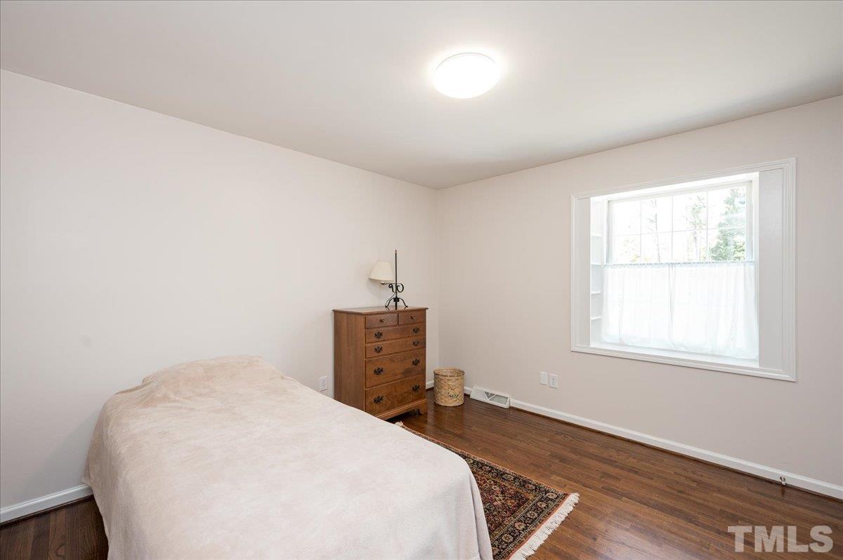 2012 Eagleton Circle Raleigh, NC 27609 - Photo 28 of 29 a bedroom with a bed and wooden floor