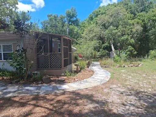 a view of a barn house in the middle of forest